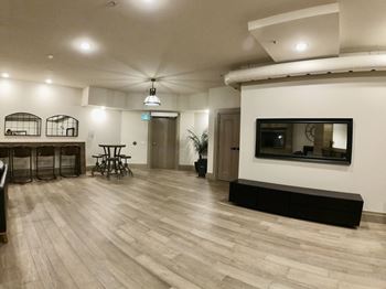 Creekside Common room living room filled with furniture and a large flat screen tv